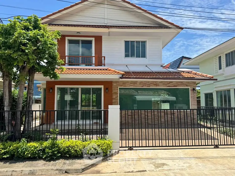 Charming two-story house with a spacious front yard and modern design in a serene neighborhood.