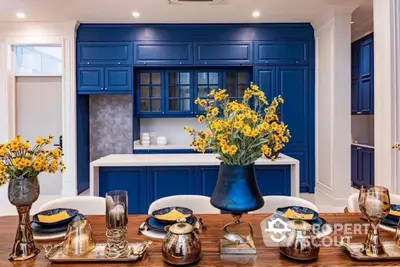 Luxurious kitchen with elegant blue cabinetry and stylish dining setup