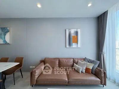Modern living room with stylish brown leather sofa and elegant decor