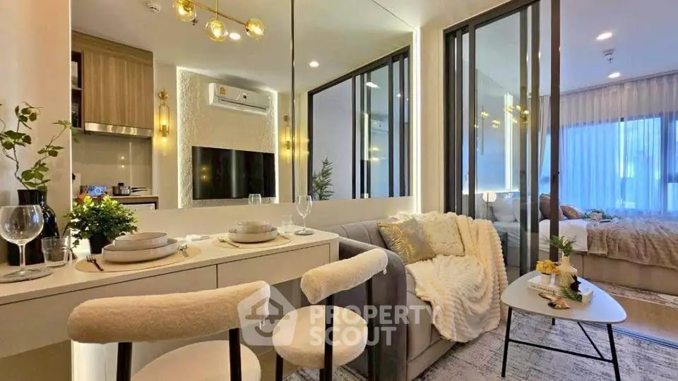 Modern open-plan living room with stylish decor and cozy bedroom view.