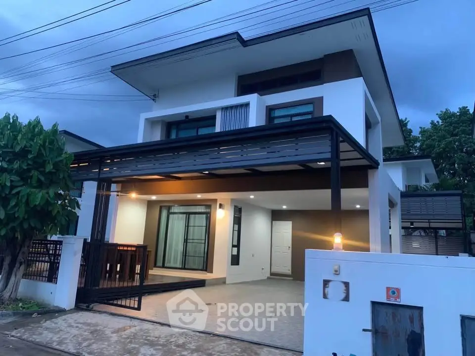 Modern two-story house with sleek design and spacious driveway at dusk.