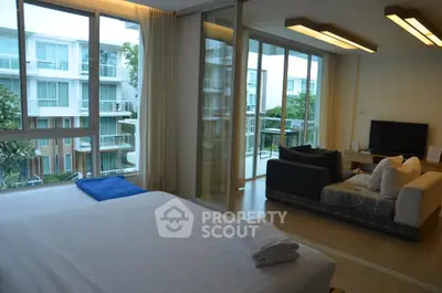 Spacious modern living room with large windows and balcony view in luxury apartment