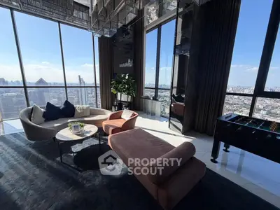Luxurious high-rise living room with panoramic city views and modern furnishings.