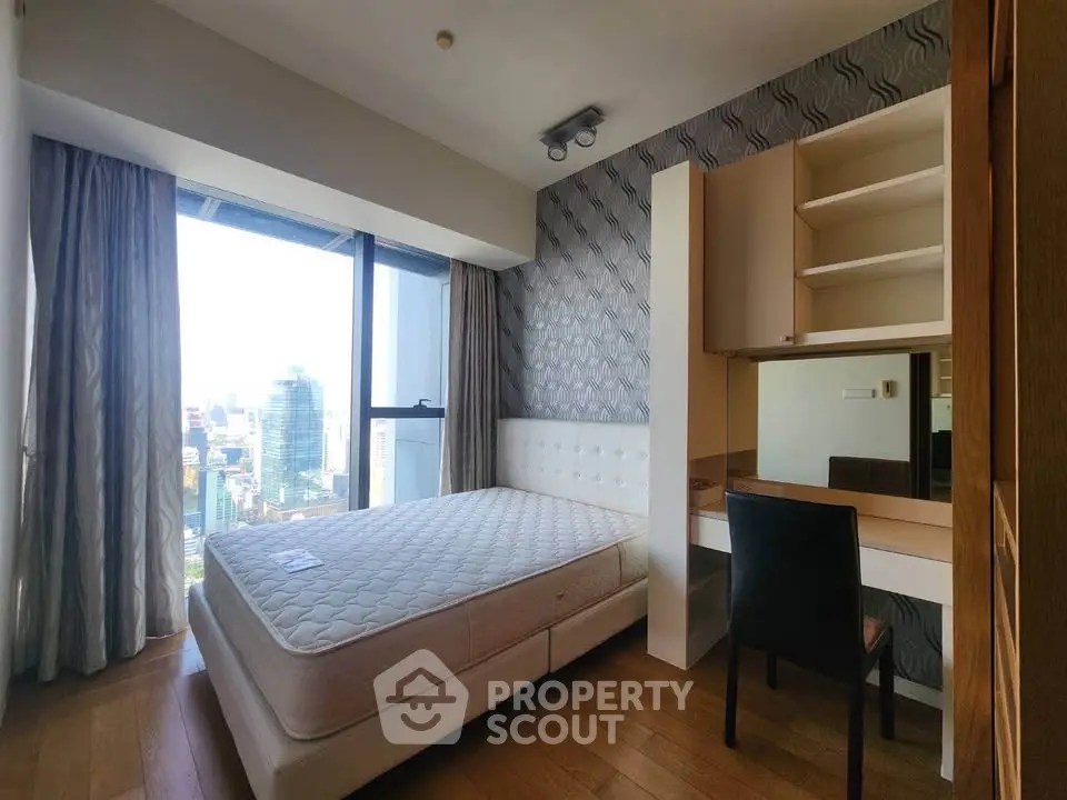 Modern bedroom with city view, featuring stylish decor and ample natural light.