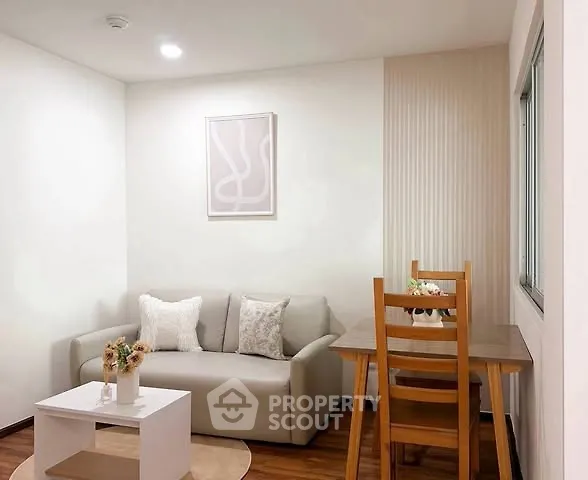 Cozy living room with modern decor and dining area, perfect for relaxation and entertaining.