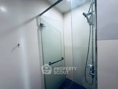 Modern bathroom with glass shower enclosure and sleek fixtures