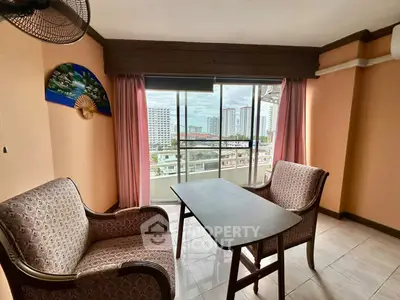 Cozy living room with city view, featuring elegant armchairs and a wooden table near large windows.