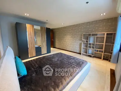 Spacious modern bedroom with stylish decor and ample storage space