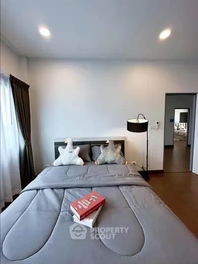 Modern bedroom with cozy bedding and stylish decor in a contemporary apartment.