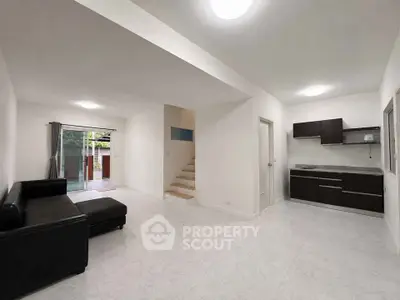 Spacious modern living room with open layout and sleek kitchen design