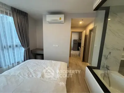 Modern bedroom with ensuite bathroom and air conditioning in a stylish apartment.