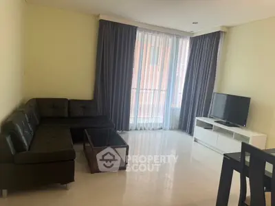 Spacious living room with modern furniture and large window for natural light.