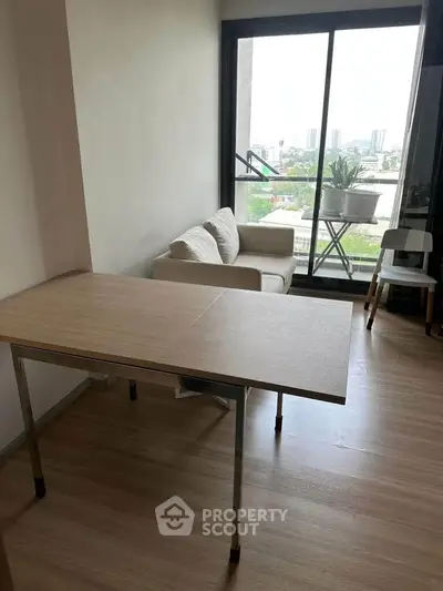 Modern living room with city view, featuring a cozy sofa and wooden table, perfect for urban living.