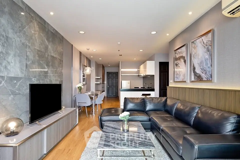 Luxurious modern living room with leather sofa and open kitchen layout
