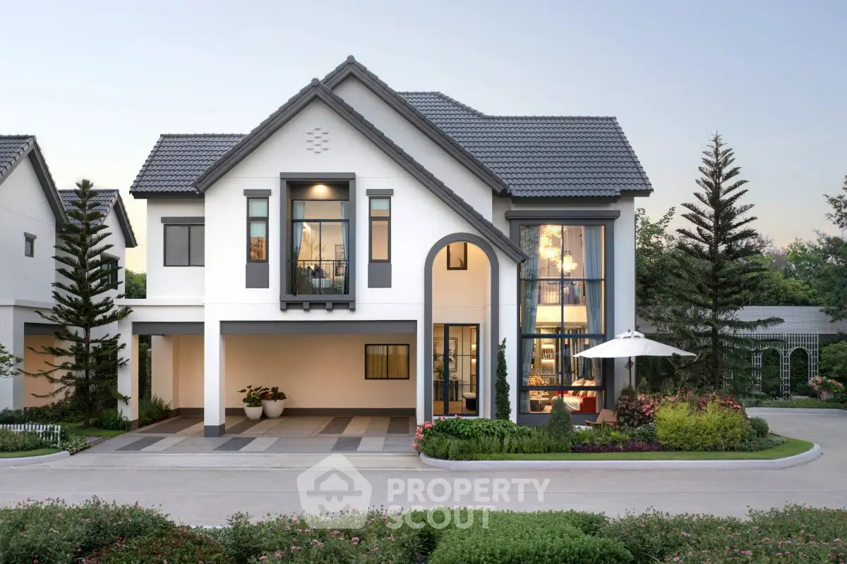Stunning modern two-story house with large windows and landscaped garden.