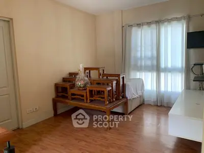 Spacious living room with wooden flooring and natural light