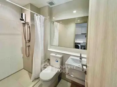 Modern bathroom with sleek fixtures and a large mirror in a contemporary apartment.
