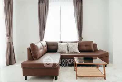 Modern living room with stylish brown sectional sofa and elegant curtains