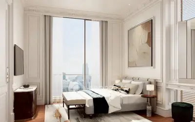 Luxurious bedroom with city view, elegant decor, and modern furnishings in high-rise apartment.