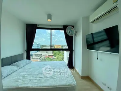Bright bedroom with large window and city view, featuring modern amenities and minimalist design.
