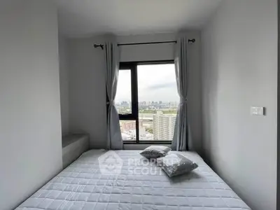 Cozy bedroom with city view, featuring a large window and minimalist decor.