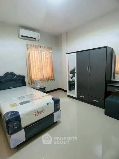 Cozy bedroom with modern furniture and natural light, perfect for relaxation.
