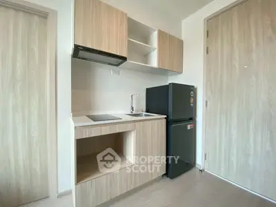 Modern compact kitchen with sleek cabinetry and appliances
