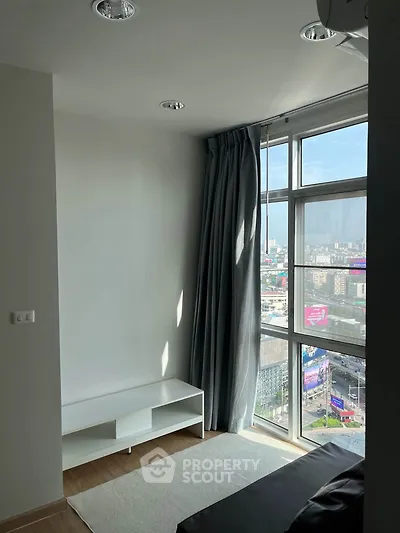 Modern apartment with large windows offering stunning city views and natural light.