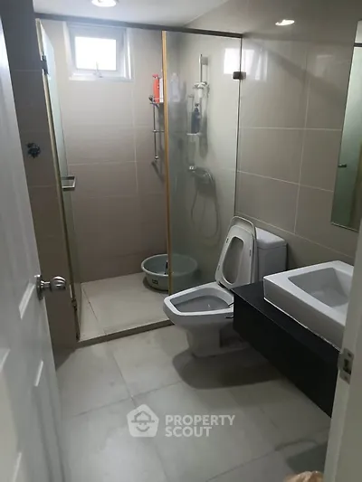 Modern bathroom with glass shower and sleek fixtures