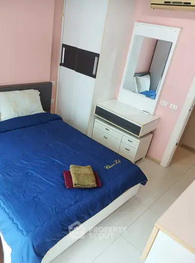 Cozy bedroom with blue bedding and modern furniture in a stylish apartment.