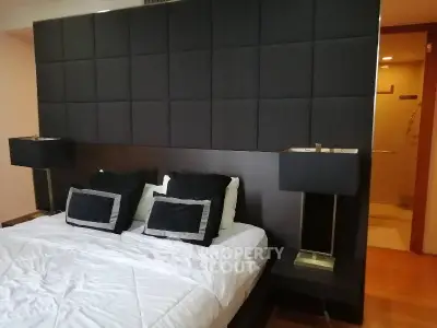 Luxurious bedroom with elegant black headboard and modern lamps