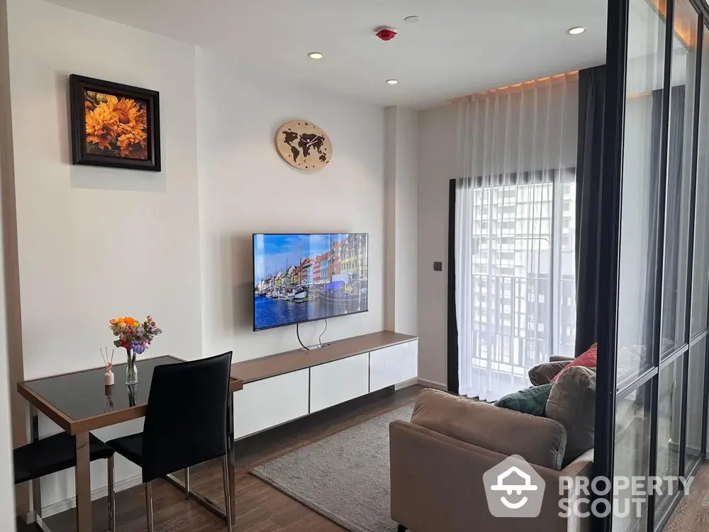 Modern living room with wall-mounted TV and balcony view