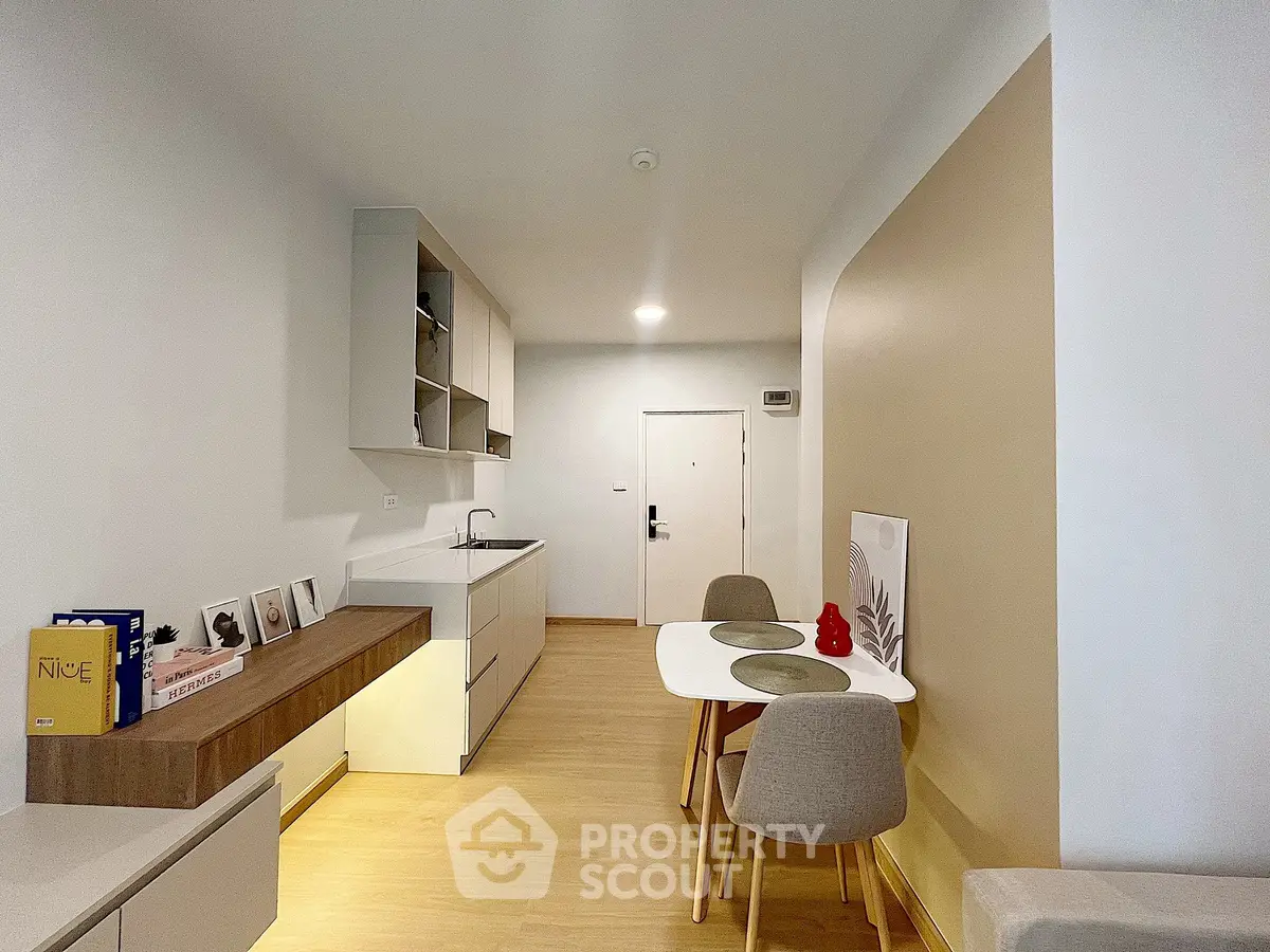 Modern minimalist kitchen with dining area and sleek cabinetry
