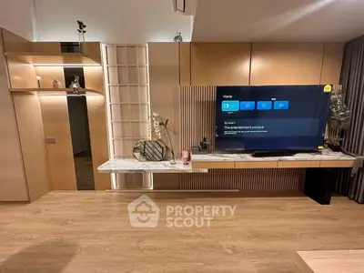Modern living room with sleek wooden flooring and stylish TV setup