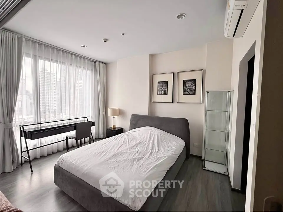 Spacious bedroom with city view and modern furnishings