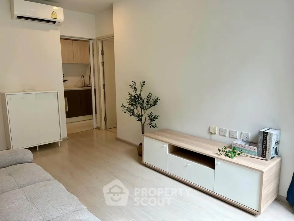 Modern living room with minimalist decor and open kitchen layout