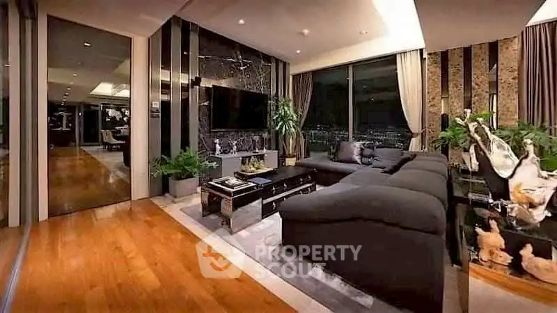 Luxurious living room with modern decor and stunning city view, featuring sleek furniture and elegant design.