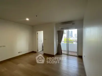 Spacious empty room with balcony view in modern apartment
