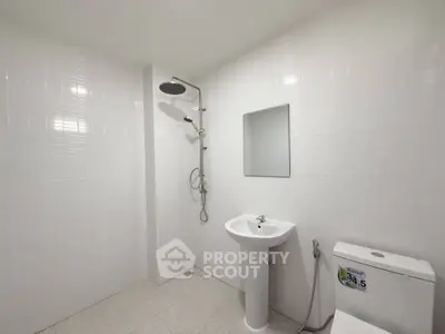 Modern minimalist bathroom with sleek fixtures and white tiles