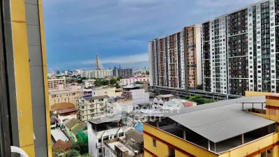 Stunning cityscape view from high-rise apartment balcony with modern buildings and skyline.