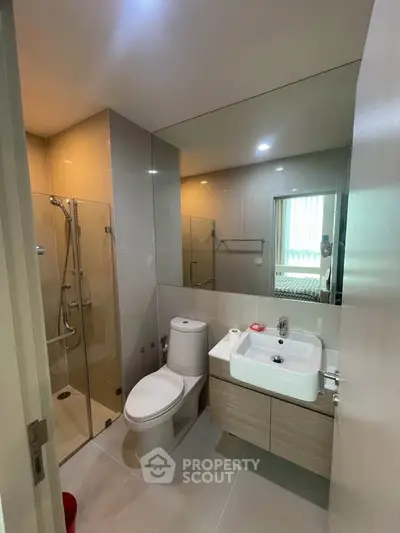 Modern bathroom with glass shower and sleek fixtures