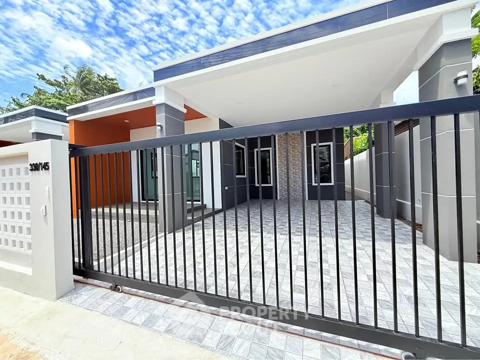 Modern single-story house with sleek design and gated entrance, perfect for contemporary living.