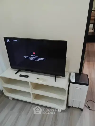 Modern living room with sleek TV setup and stylish furniture, perfect for entertainment and relaxation.