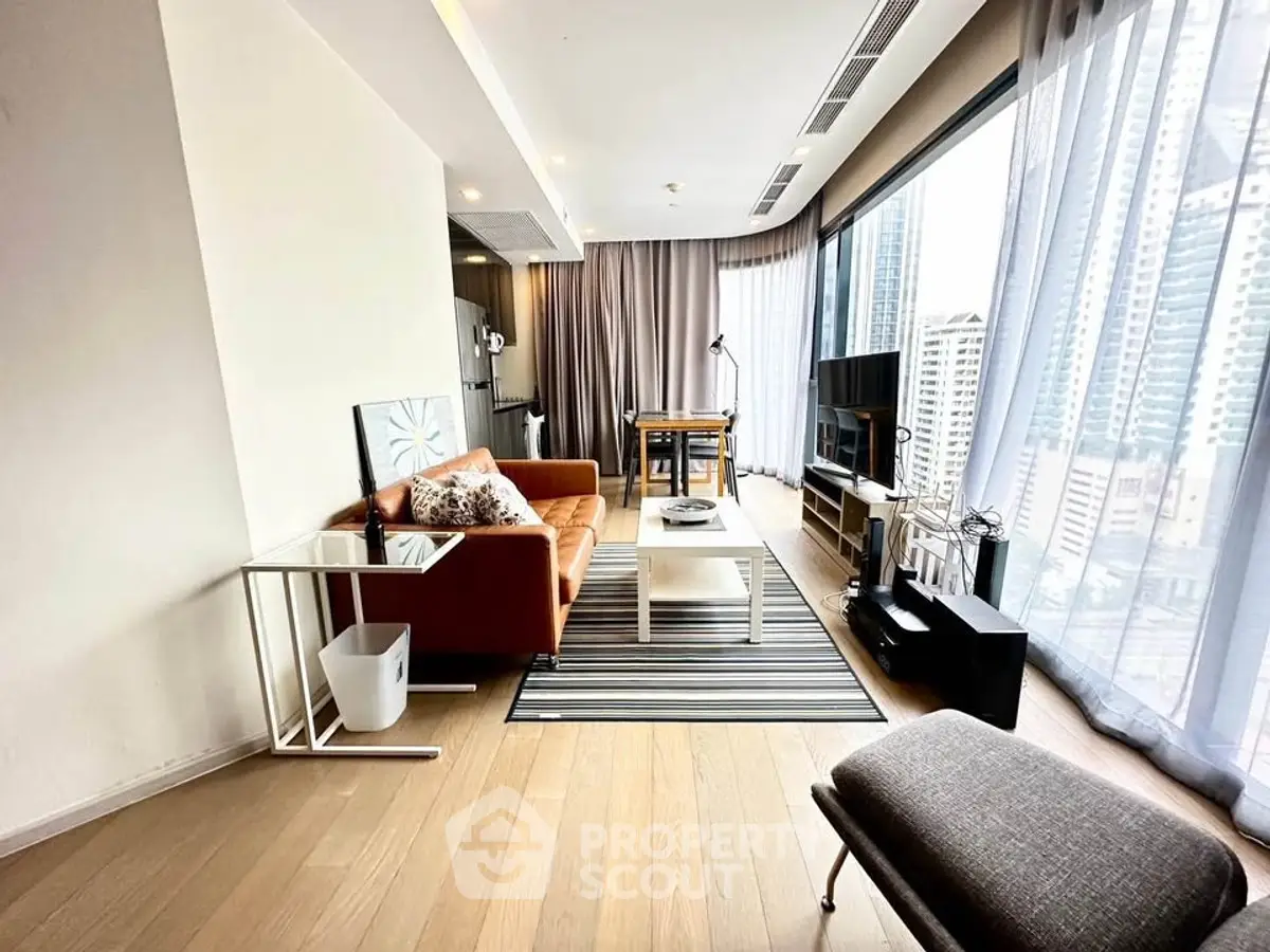 Modern living room with floor-to-ceiling windows and city view, featuring stylish furniture and decor.