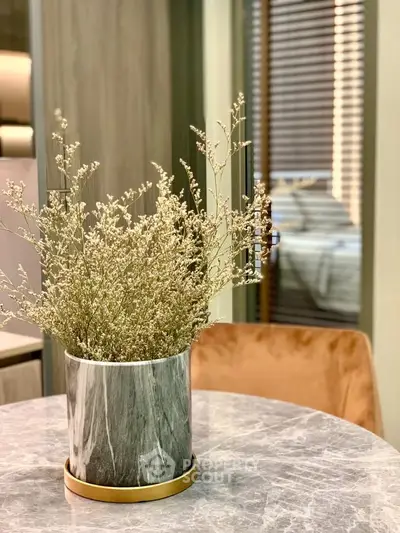 Elegant interior with marble table and stylish decor in modern living space.