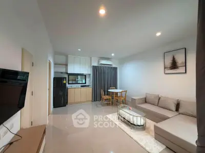 Modern living room with open kitchen, sleek furniture, and elegant decor in a stylish apartment.