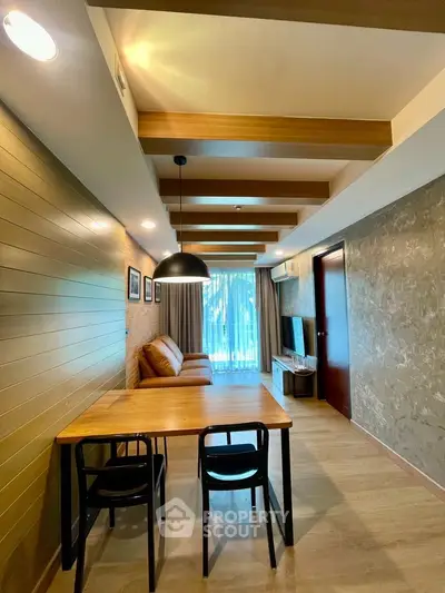 Modern living room with stylish wooden beams and cozy seating area, perfect for relaxation.