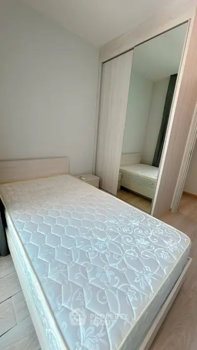 Cozy bedroom with mirrored wardrobe and comfortable mattress