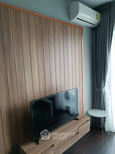 Modern living room with sleek wooden paneling and flat-screen TV