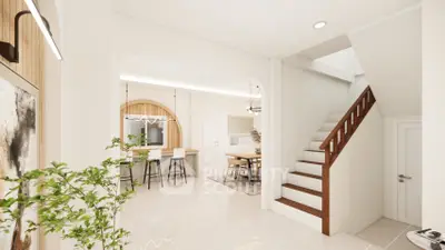 Modern open-plan living area with stylish staircase and dining space